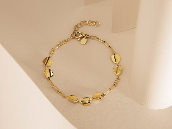 Link zu Armbändern. Ein goldenes Armband mit Herzen.