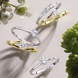 Solitärringe aus Gold und Silber auf einem Leinentuch.